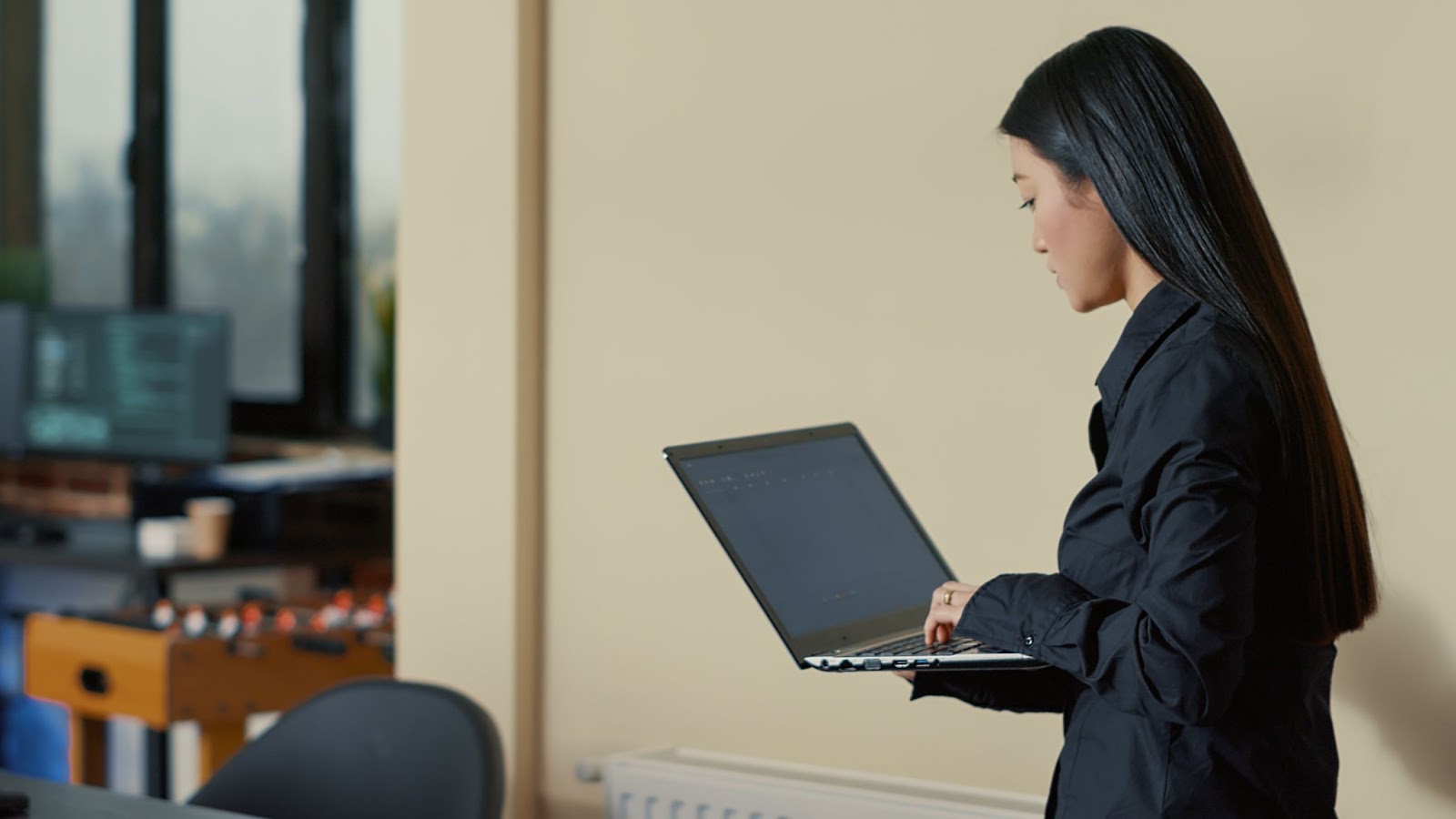 A woman holding a laptop