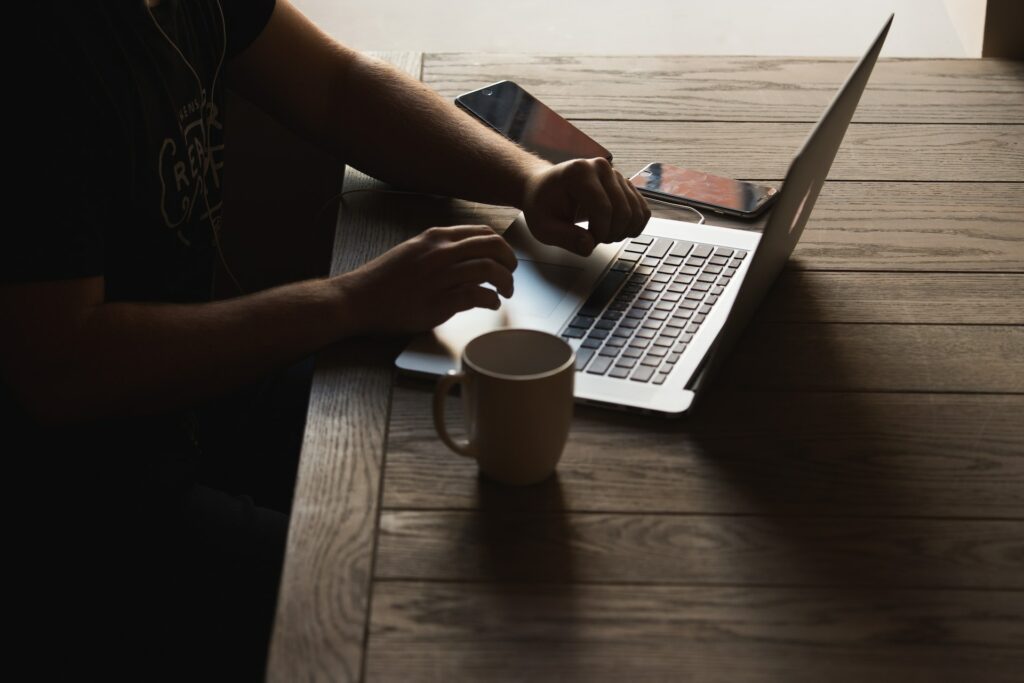man sitting at laptop