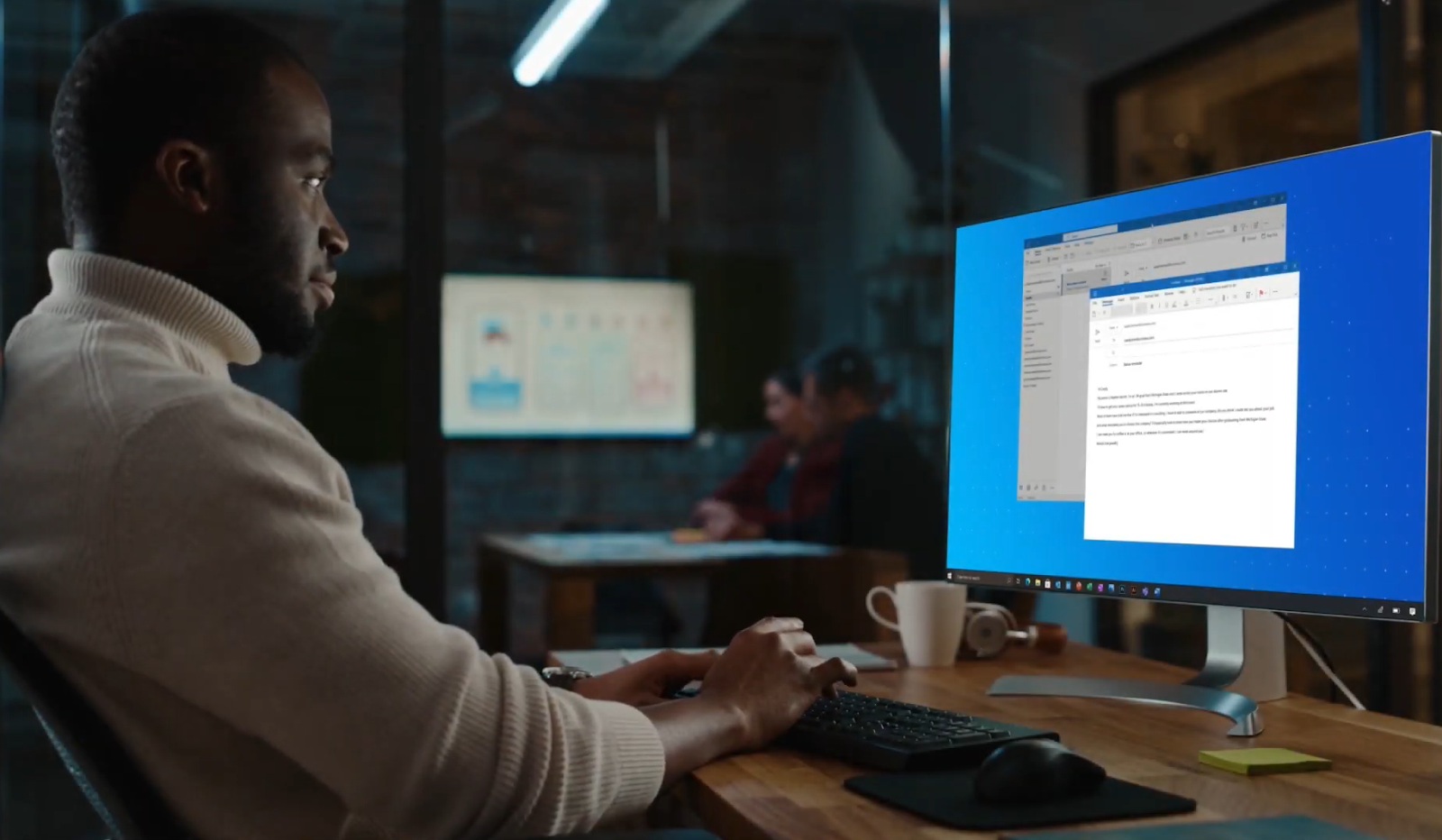 man sitting at computer and typing on the keyboard while watching on the screen